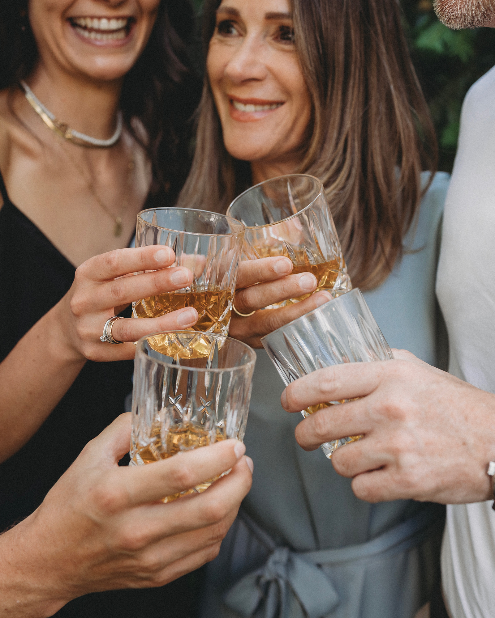 Vier Menschen stoßen mit Amaro Amarill pur auf Eis an.